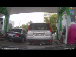 woman mixed up cars at a gas station